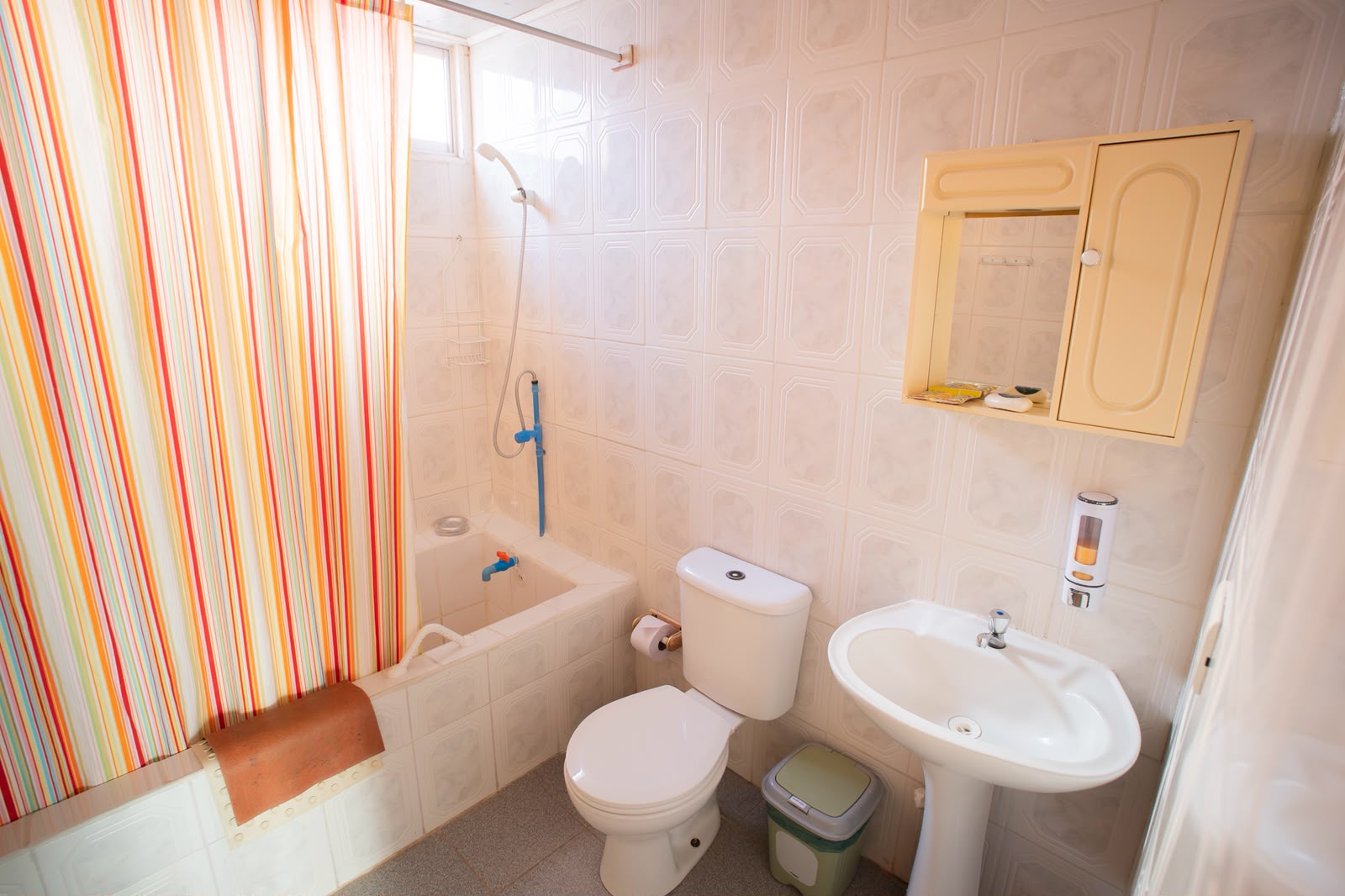 Baño del alojamiento con ducha y cortina de colores